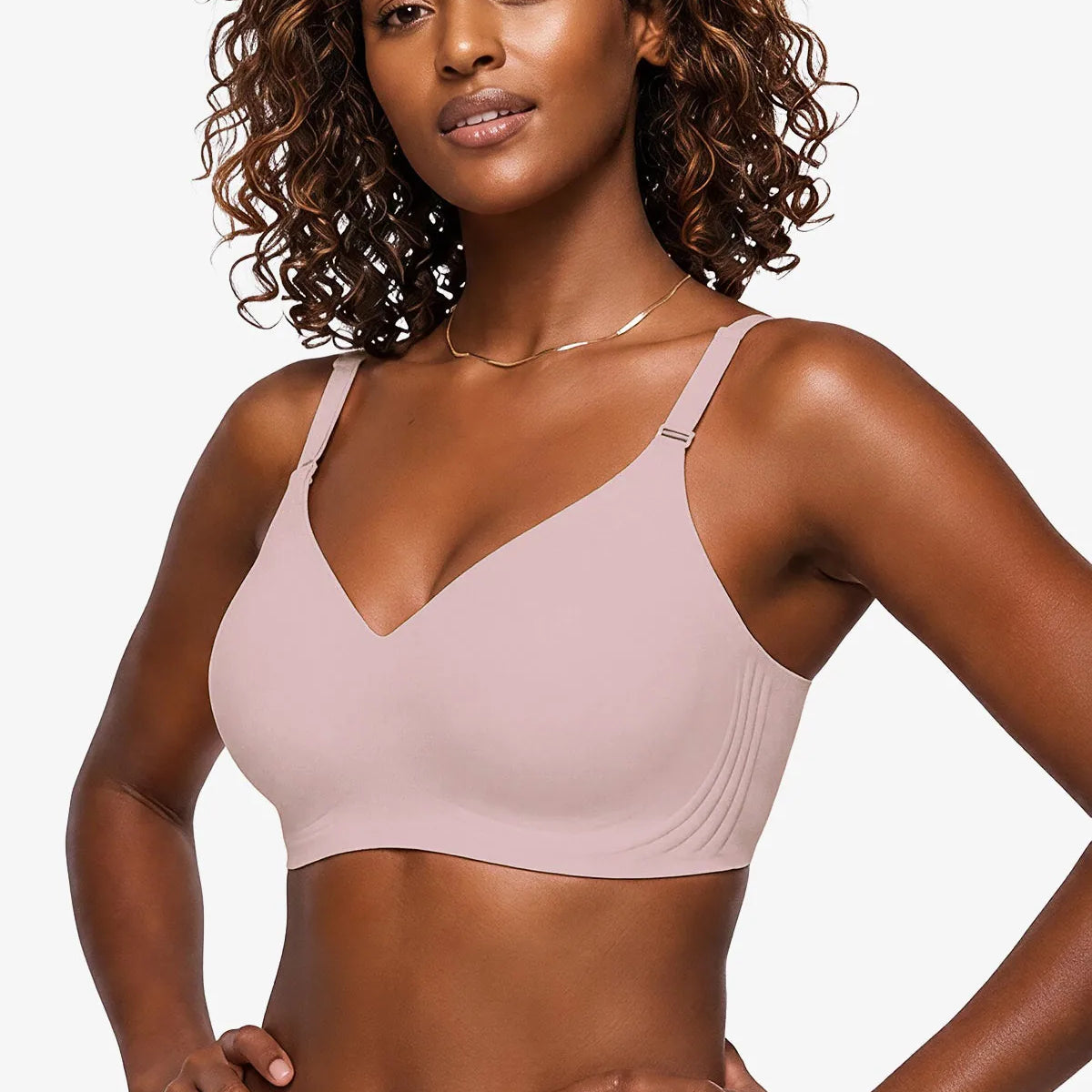 Pink seamless plunge bra with thin adjustable straps, no underwire.