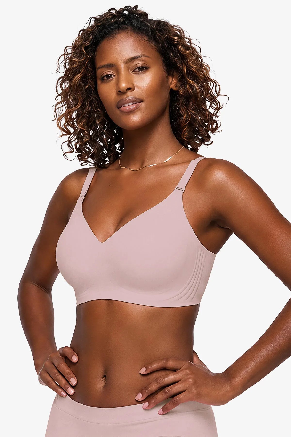 Pink seamless plunge bra with thin adjustable straps, no underwire.